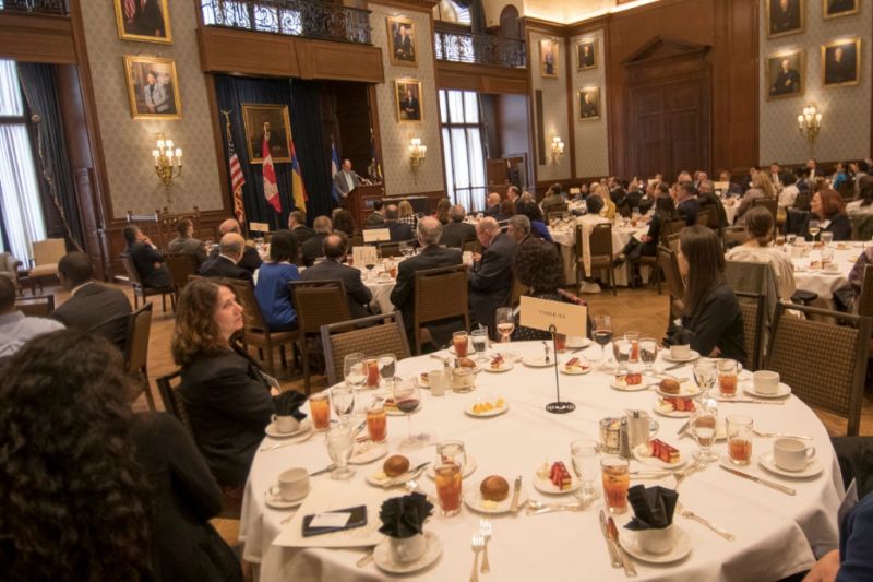 Close-up view of round dinner table with place settings during Pan American Day 2019 formal event.